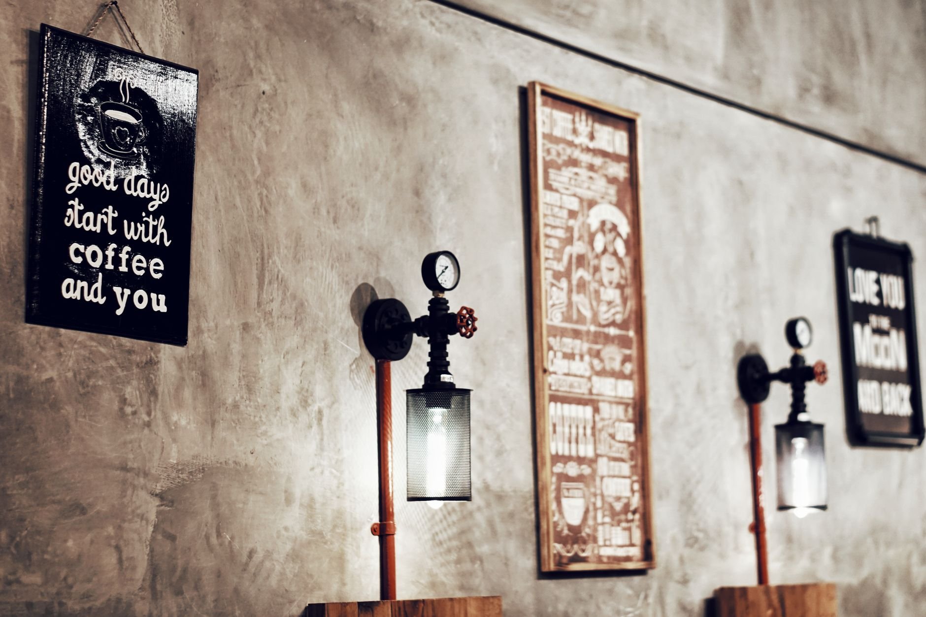 Stylish coffee shop interior with vintage decor and inspirational quotes on the wall.